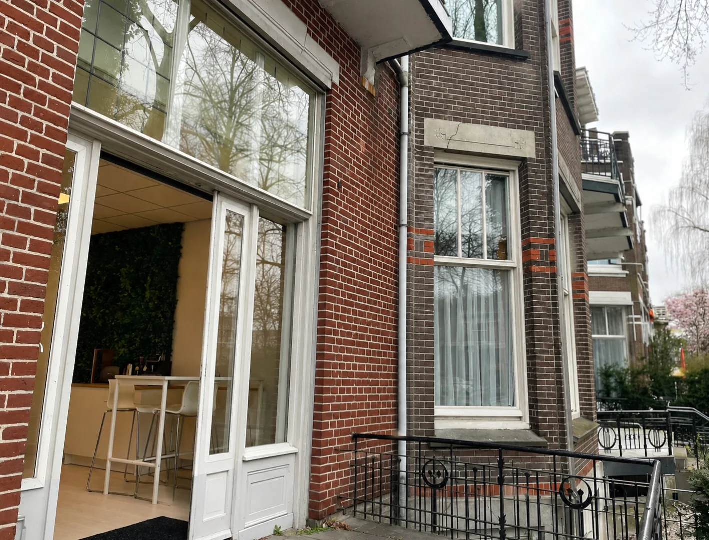 The Agentancy office on the Oranjesingel in Nijmegen: a listed building with its front door open and a view of the meeting table inside.